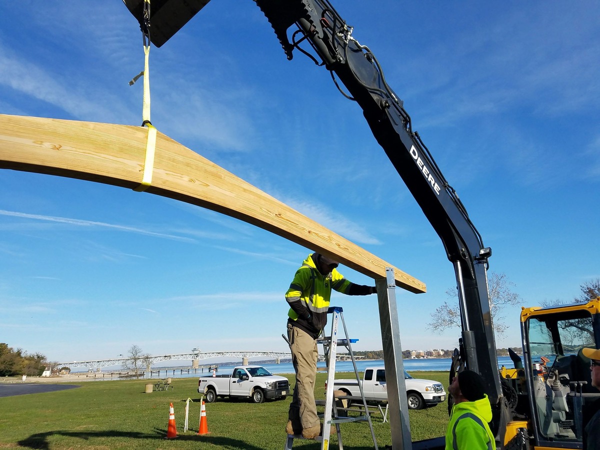 Setting glue laminated beams for new park shelter structure