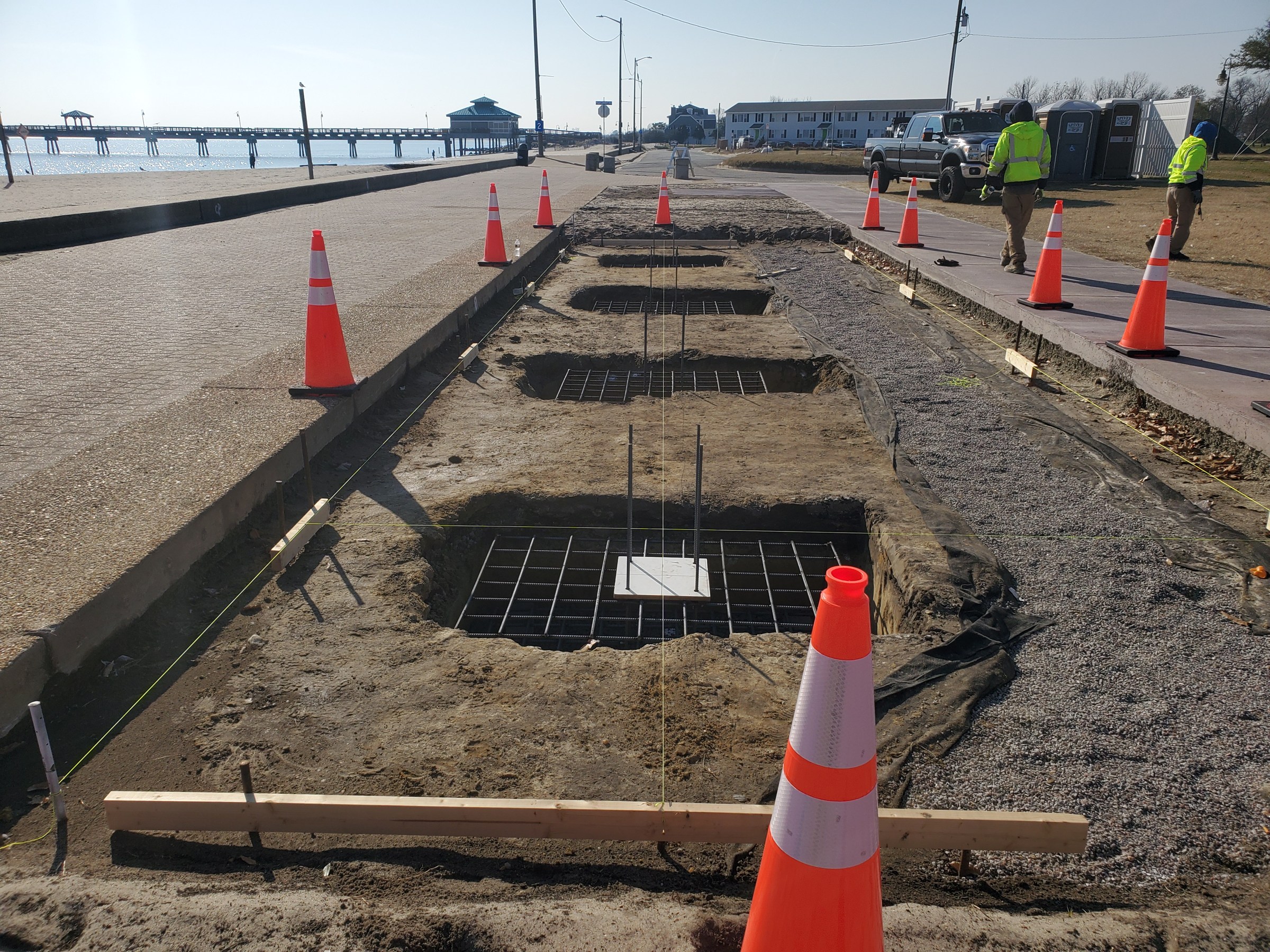 Forms and reinforcement establish the foundations along the waterfront.